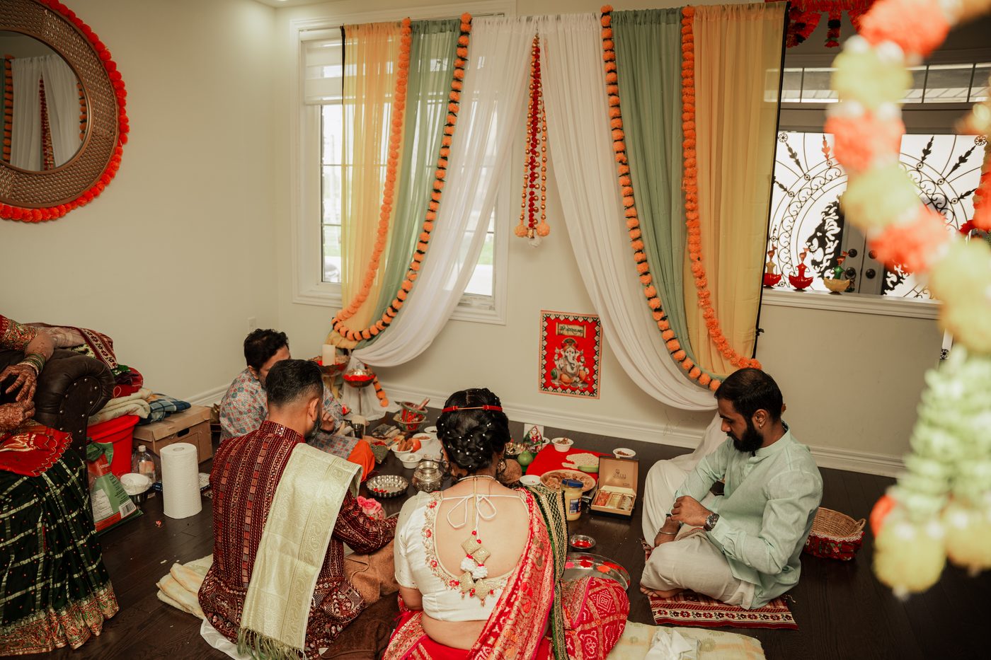 A mehndi stage with decorative umbrellas and lanterns