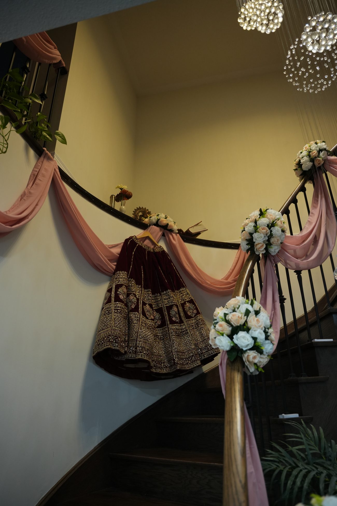 A staircase dressed with florals and pink draping